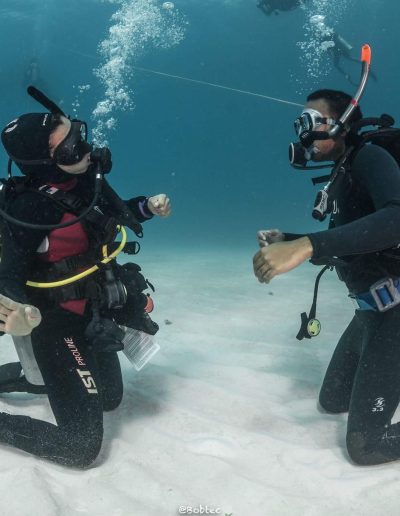 Diver and Instructor practicing bouyancy at the ocean