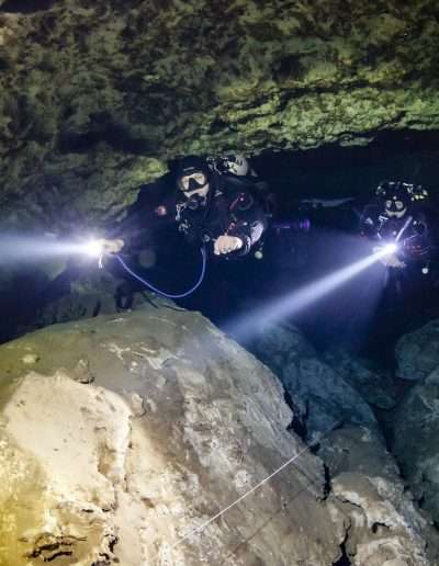 Cave divers exploring Yucatan underwater cave